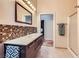 Modern bathroom featuring a double vanity with stylish backsplash and a glass-enclosed shower at 440 N Lisbon St, Henderson, NV 89015