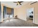 Bright bedroom featuring neutral walls, a ceiling fan and an ensuite bathroom at 440 N Lisbon St, Henderson, NV 89015