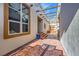 Inviting courtyard with stone flooring, exposed beams, and natural light leading to the front door at 440 N Lisbon St, Henderson, NV 89015