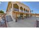 Exterior view of a stucco home with a covered patio and landscaped surroundings at 440 N Lisbon St, Henderson, NV 89015