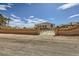 Wide shot of the building behind a low brick wall with an iron gate at 440 N Lisbon St, Henderson, NV 89015
