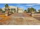 Charming single-story home featuring stucco exterior, desert landscaping, and a spacious driveway at 440 N Lisbon St, Henderson, NV 89015