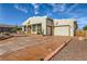 Charming single-story home featuring stucco exterior, desert landscaping, and a three-car garage at 440 N Lisbon St, Henderson, NV 89015