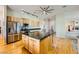Open kitchen with stainless steel appliances, a large island, and hardwood flooring at 440 N Lisbon St, Henderson, NV 89015
