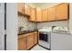 Charming laundry room with granite counters, sink, cabinetry and modern washer and dryer at 440 N Lisbon St, Henderson, NV 89015