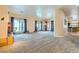 Spacious living room boasts neutral carpet, a fireplace, and large windows for natural light at 440 N Lisbon St, Henderson, NV 89015