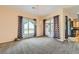 Spacious living room with chandelier lighting and sliding glass doors leading to a patio at 440 N Lisbon St, Henderson, NV 89015