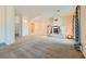 Spacious living room featuring neutral carpet, a unique fireplace, and ample natural light at 440 N Lisbon St, Henderson, NV 89015