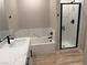 Modern bathroom with double vanity, white countertops, sleek black fixtures, and glass enclosed shower at 4409 Pioche Ave, North Las Vegas, NV 89032