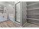 Modern bathroom featuring a walk-in shower with glass door and shelving at 4409 Pioche Ave, North Las Vegas, NV 89032