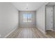 Bright, open living room with wood-look floors and a large window at 4409 Pioche Ave, North Las Vegas, NV 89032