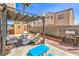 Relax on the covered patio in this backyard oasis featuring seating and a grill for outdoor gatherings at 4514 Calico Cliff Ct, North Las Vegas, NV 89031