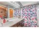 Bathroom featuring double sinks, vanity lighting, and a geometric patterned shower curtain at 4514 Calico Cliff Ct, North Las Vegas, NV 89031