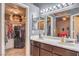 Bathroom featuring double sinks, vanity lighting, and a mirrored medicine cabinet over the toilet at 4514 Calico Cliff Ct, North Las Vegas, NV 89031