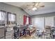 Bedroom features a ceiling fan, two windows, and a futon and rolling closet at 4514 Calico Cliff Ct, North Las Vegas, NV 89031