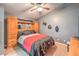 Bedroom features a ceiling fan, carpet flooring, and a full bed with wood headboard and built in shelving at 4514 Calico Cliff Ct, North Las Vegas, NV 89031