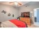 Bedroom features a ceiling fan, carpet flooring, a full bed with night stands and a TV on a dresser at 4514 Calico Cliff Ct, North Las Vegas, NV 89031