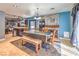 Open-concept dining area featuring a stone fireplace, island with seating, and a sun-drenched window at 4514 Calico Cliff Ct, North Las Vegas, NV 89031