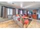 Comfortable living room with tile flooring, TV, and large window at 4514 Calico Cliff Ct, North Las Vegas, NV 89031