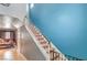 Carpeted staircase with white railings, ascending to the upper level with vibrant blue accent walls at 4514 Calico Cliff Ct, North Las Vegas, NV 89031