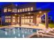 Backyard with a pool, spa, outdoor kitchen, and modern patio furniture at 5429 Succulent Rose Dr, Las Vegas, NV 89135