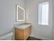 Well-lit bathroom with a sleek vanity, lighted mirror, and modern fixtures next to a window at 5429 Succulent Rose Dr, Las Vegas, NV 89135