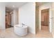 Bathroom featuring a modern stand alone tub and an open glass shower at 5429 Succulent Rose Dr, Las Vegas, NV 89135
