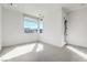 Empty bedroom featuring a large corner window, with light carpet flooring at 5429 Succulent Rose Dr, Las Vegas, NV 89135