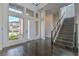 Bright foyer featuring hardwood floors, staircase, and a modern front door with sidelights at 5429 Succulent Rose Dr, Las Vegas, NV 89135