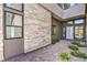 Home's front entrance with stone accent wall, paved walkway, and desert landscaping at 5429 Succulent Rose Dr, Las Vegas, NV 89135