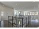 A second story hallway with an open metal railing and a hardwood floor at 5429 Succulent Rose Dr, Las Vegas, NV 89135