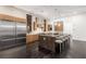 Modern kitchen featuring a large island, stainless steel appliances, and dark wood floors at 5429 Succulent Rose Dr, Las Vegas, NV 89135