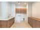 Spacious laundry room with ample counter space and overhead cabinets for storage and organization at 5429 Succulent Rose Dr, Las Vegas, NV 89135