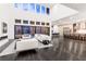 Spacious open-concept living area with hardwood floors, fireplace, and sliding glass doors to the backyard at 5429 Succulent Rose Dr, Las Vegas, NV 89135