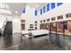 Bright living room with soaring ceilings, modern fireplace, dark wood flooring, and access to the backyard at 5429 Succulent Rose Dr, Las Vegas, NV 89135