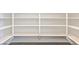 A well-organized, empty walk-in pantry with white shelving units at 5429 Succulent Rose Dr, Las Vegas, NV 89135