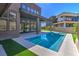 Backyard with a modern pool, patio, and lush artificial grass at 5429 Succulent Rose Dr, Las Vegas, NV 89135