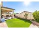 Well-manicured backyard with a manicured lawn and covered patio, perfect for entertaining at 5633 Alitak Bay St, North Las Vegas, NV 89081