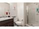 Bright bathroom featuring a single sink, granite countertops, toilet, and a glass-enclosed shower at 5633 Alitak Bay St, North Las Vegas, NV 89081