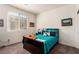 Cozy bedroom featuring natural light from a window with a comfortable bed and soft furnishings at 5633 Alitak Bay St, North Las Vegas, NV 89081