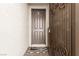 Inviting front entrance featuring a secure decorative iron security door and a neutral colored front door and tiled entryway at 5633 Alitak Bay St, North Las Vegas, NV 89081