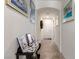 Bright hallway featuring tile flooring, neutral walls adorned with tasteful artwork, and an arched doorway leading to the main entrance at 5633 Alitak Bay St, North Las Vegas, NV 89081
