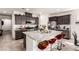 Stylish kitchen featuring dark cabinets, a center island with breakfast bar, and granite countertops at 5633 Alitak Bay St, North Las Vegas, NV 89081