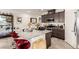 Updated kitchen featuring a center island with barstool seating, stainless appliances and wood cabinetry at 5633 Alitak Bay St, North Las Vegas, NV 89081