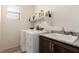 Laundry room featuring granite countertops, modern washer and dryer for convenience at 5633 Alitak Bay St, North Las Vegas, NV 89081