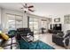 Spacious living room features tile flooring, neutral paint, a ceiling fan and sliding doors that provide ample natural light at 5633 Alitak Bay St, North Las Vegas, NV 89081