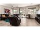 Spacious living room features tile flooring, neutral paint, a ceiling fan and sliding doors that provide ample natural light at 5633 Alitak Bay St, North Las Vegas, NV 89081