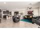 Open-concept living room featuring tile floors, ceiling fan, and comfortable seating area with kitchen view at 5633 Alitak Bay St, North Las Vegas, NV 89081