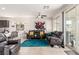 Bright living room boasts tile floors, large windows, and stylish seating area with a decorative rug at 5633 Alitak Bay St, North Las Vegas, NV 89081