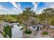 Aerial view of a well-maintained home with mature trees, desert landscaping, and a spacious driveway at 5741 S Pearl St, Las Vegas, NV 89120